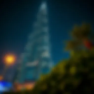 Omniyat Tower illuminated at night, highlighting its striking facade.